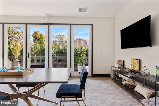 dining room with baseboards, visible vents, and wood finished floors