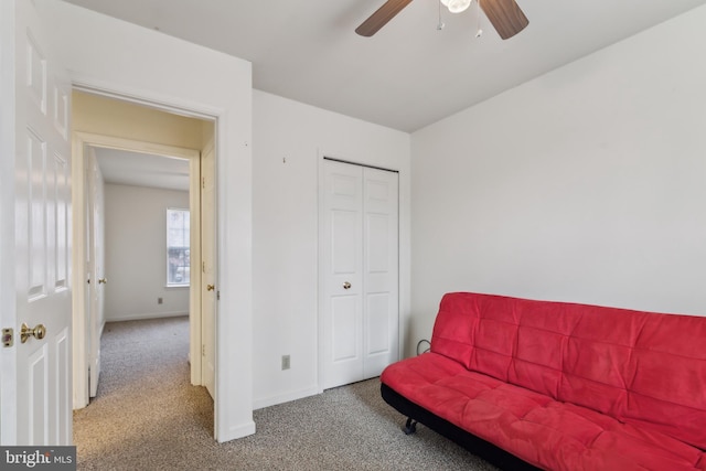 living area featuring carpet and ceiling fan