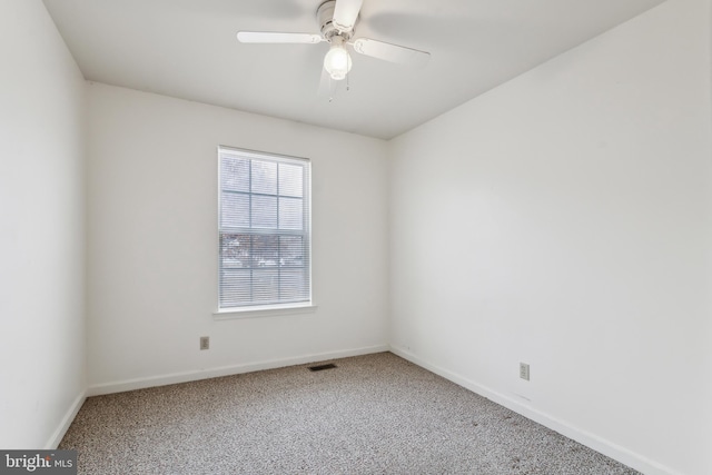 spare room with carpet floors and ceiling fan