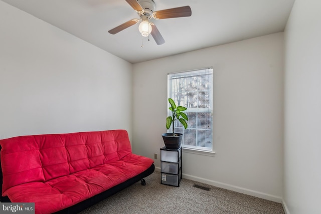 sitting room featuring ceiling fan and carpet