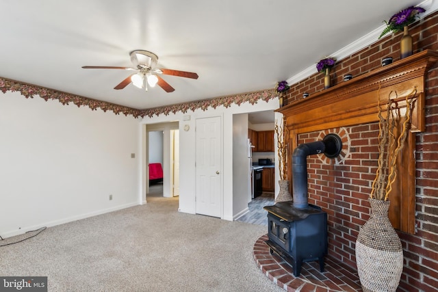 unfurnished living room featuring dark colored carpet, ceiling fan, and a wood stove