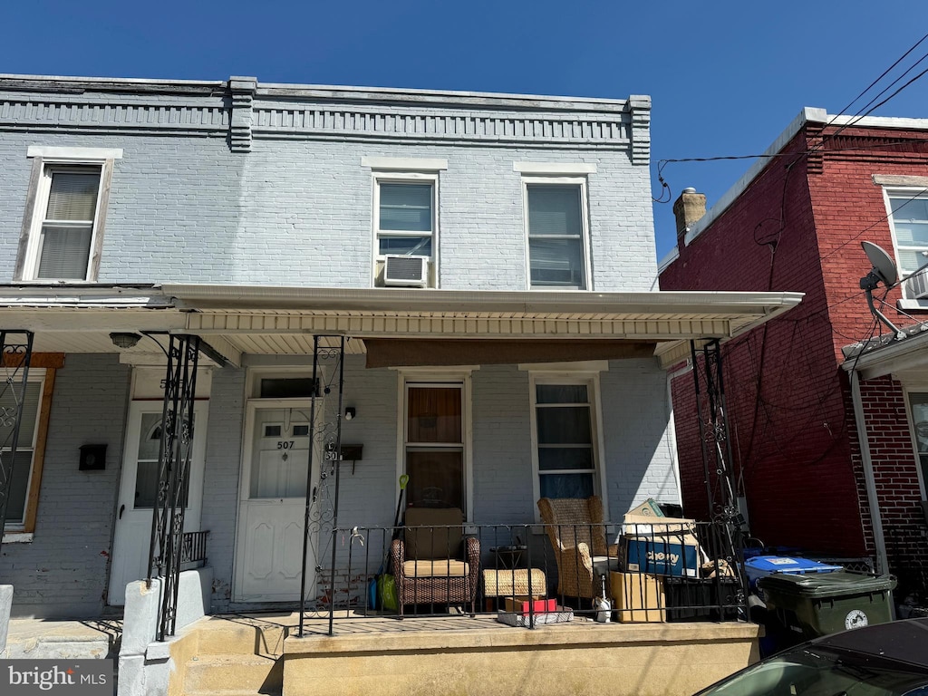 view of front facade with cooling unit and covered porch