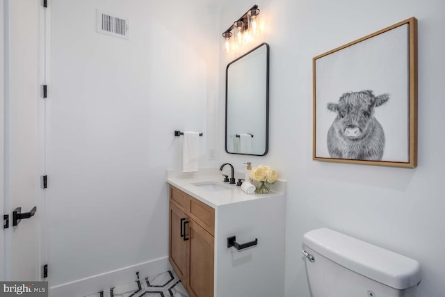 bathroom with vanity and toilet