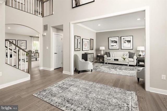 living room with hardwood / wood-style floors and ornamental molding