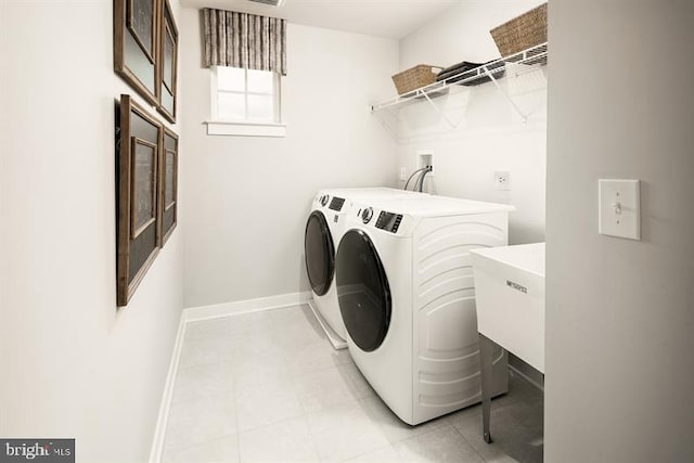 laundry area with washing machine and dryer and sink