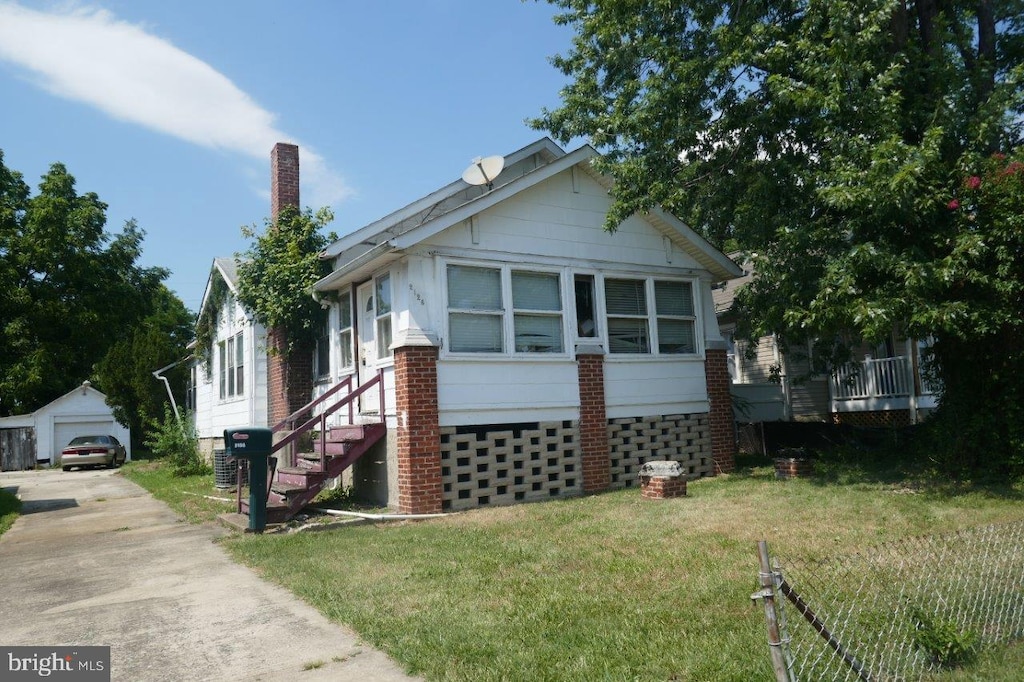 view of property exterior with an outbuilding, a garage, and a lawn