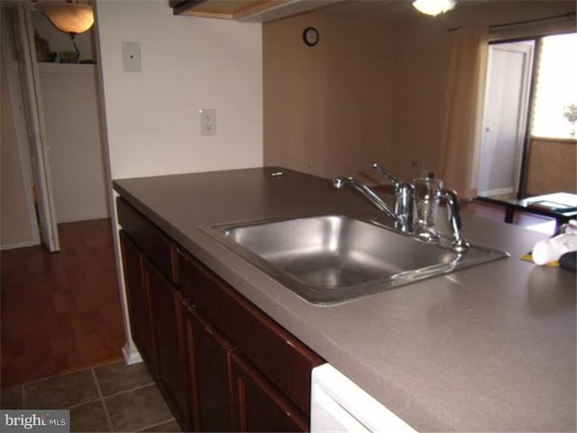 kitchen featuring sink and dark tile patterned floors