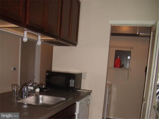 kitchen featuring dishwasher, dark brown cabinetry, and sink