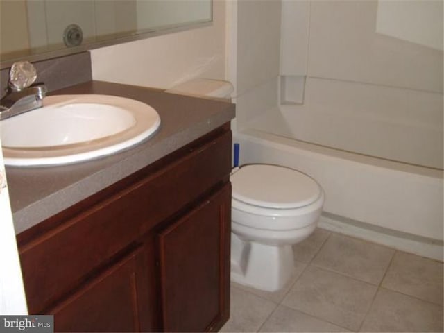 full bathroom featuring toilet, vanity, tile patterned floors, and shower / bathtub combination