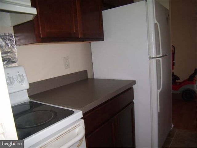 kitchen with tile patterned floors and white appliances