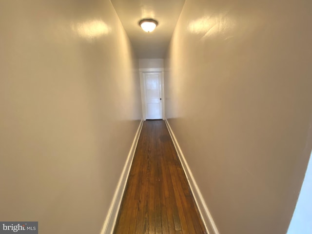 corridor featuring dark hardwood / wood-style floors