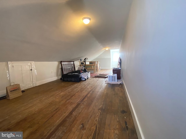 additional living space featuring vaulted ceiling and wood-type flooring