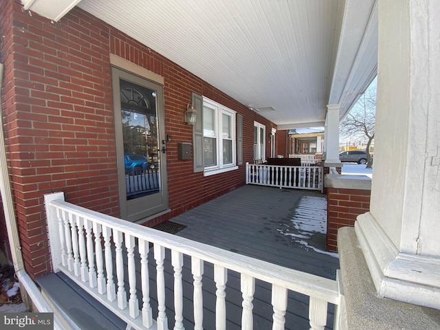 wooden terrace featuring covered porch