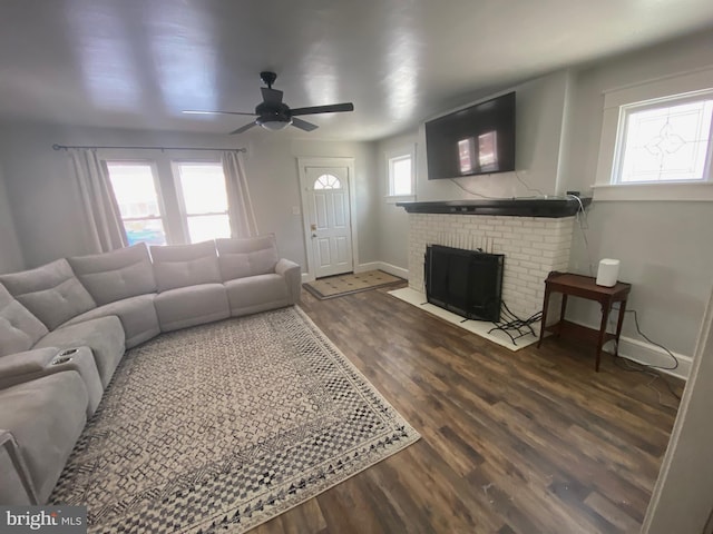 living room featuring ceiling fan, wood-type flooring, and a fireplace