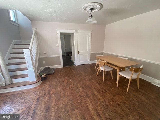 dining space featuring dark hardwood / wood-style floors