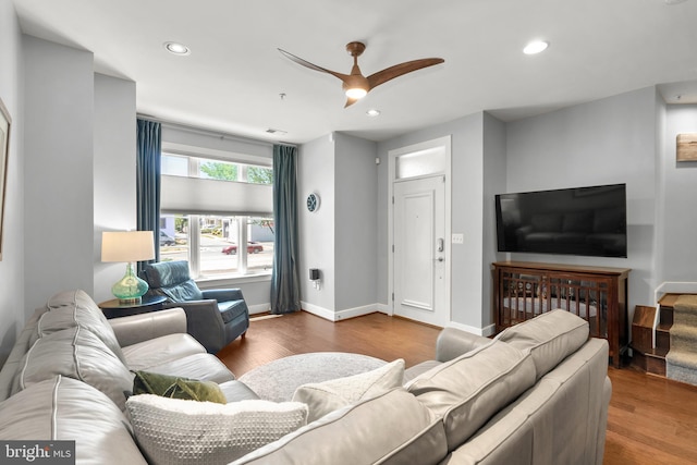 living room featuring ceiling fan and wood-type flooring