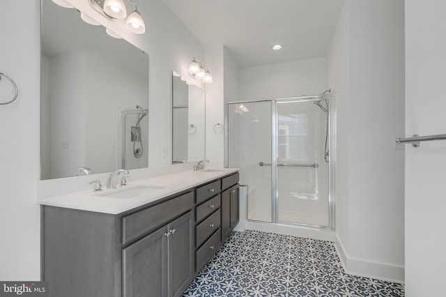 bathroom with tile patterned flooring, vanity, and an enclosed shower