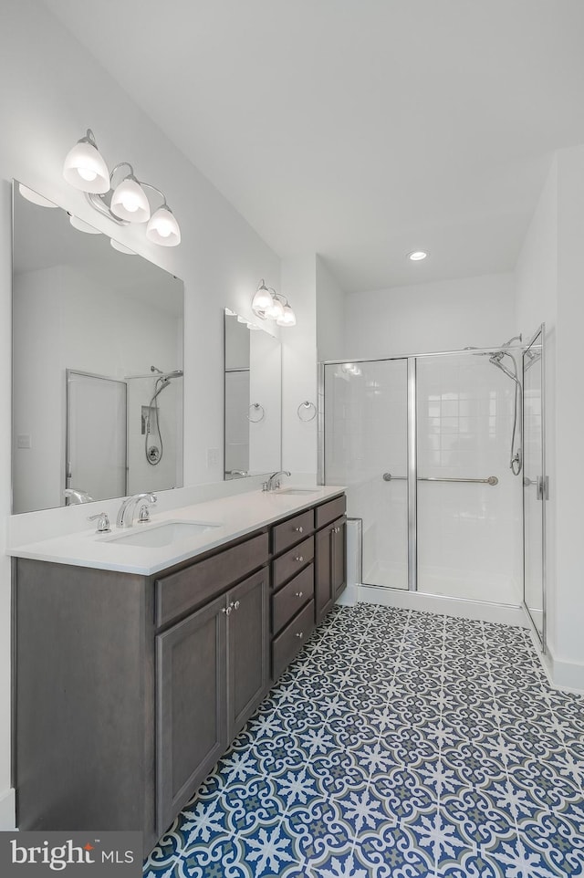 bathroom featuring vanity and a shower with shower door