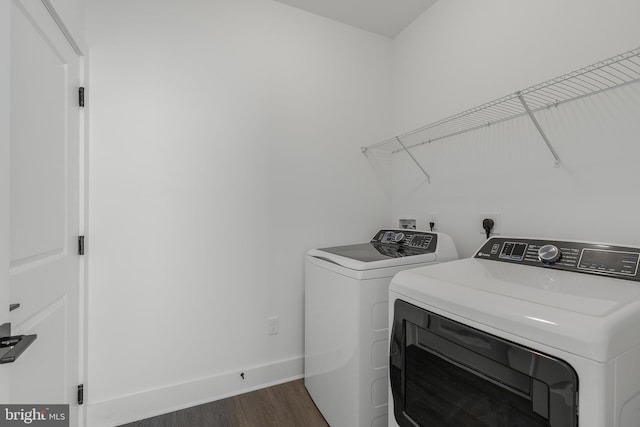 laundry area featuring dark wood-type flooring and washer and dryer