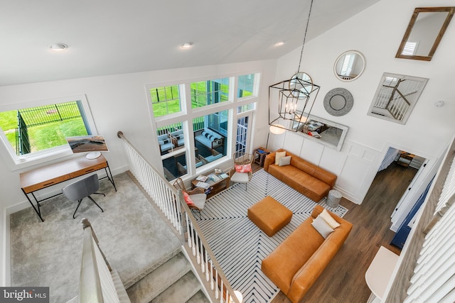 living room with vaulted ceiling and an inviting chandelier