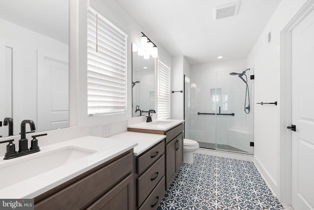 bathroom with vanity, an enclosed shower, and toilet