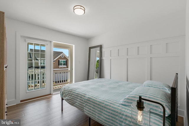 bedroom featuring access to outside and hardwood / wood-style floors