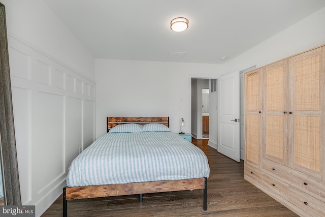 bedroom with dark wood-type flooring