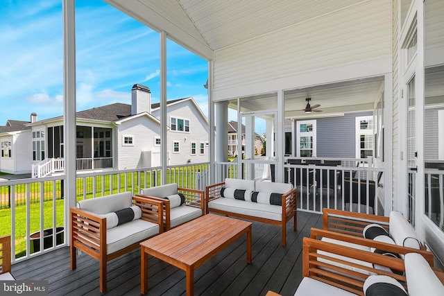 sunroom with ceiling fan and lofted ceiling