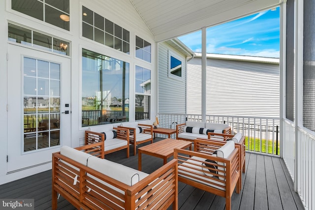 sunroom featuring lofted ceiling