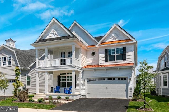 view of front of house featuring a porch and a garage