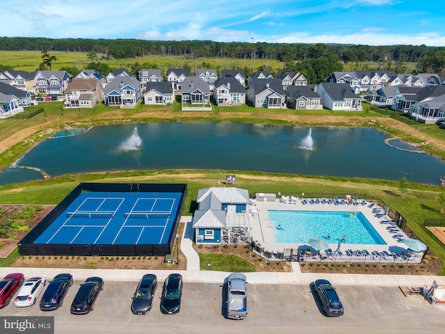 birds eye view of property with a water view