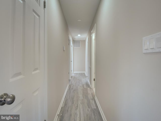 hallway with light hardwood / wood-style flooring