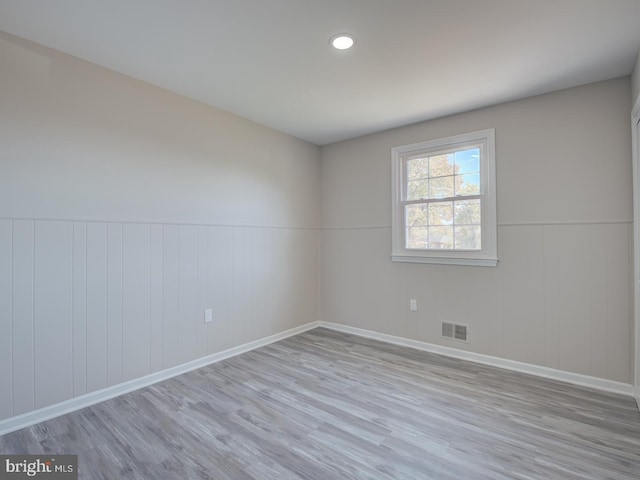 spare room featuring light hardwood / wood-style floors