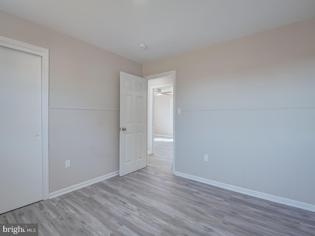 unfurnished bedroom with light hardwood / wood-style flooring and a closet