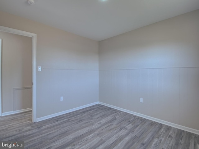 spare room featuring wood-type flooring