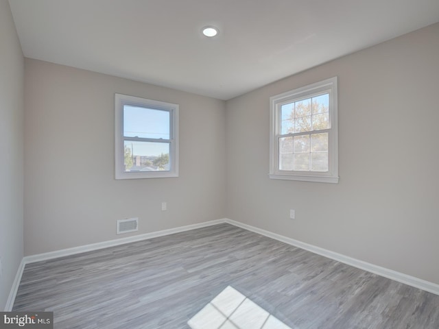 spare room featuring light hardwood / wood-style flooring