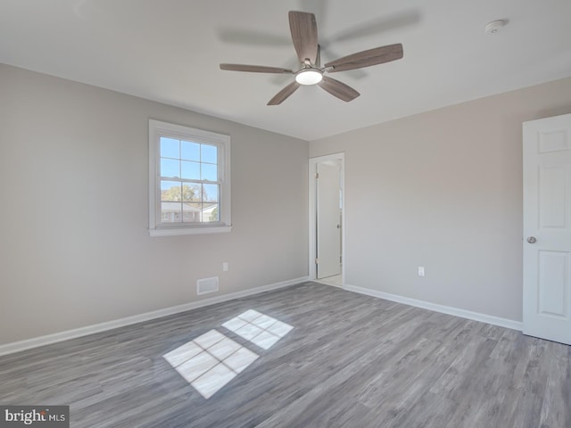 unfurnished room with ceiling fan and light hardwood / wood-style flooring