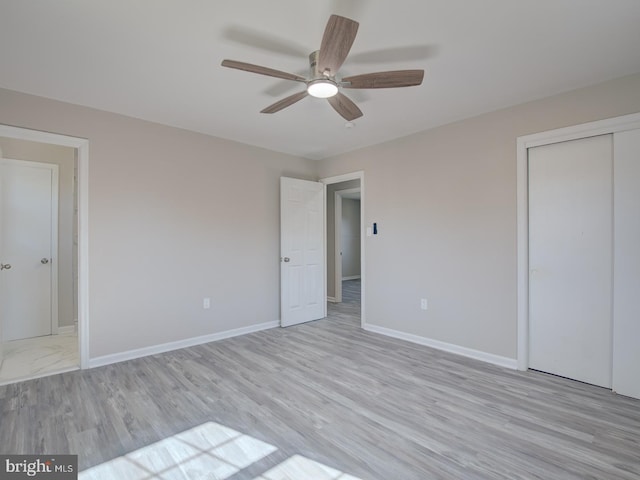 unfurnished bedroom featuring ceiling fan, a closet, and light hardwood / wood-style flooring