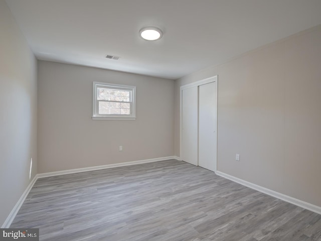 empty room with light hardwood / wood-style floors