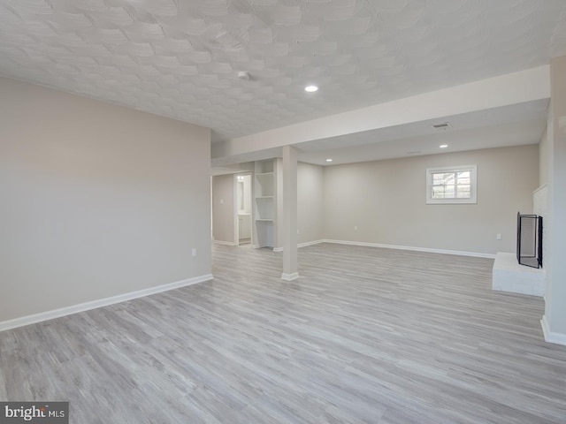 basement featuring light hardwood / wood-style flooring