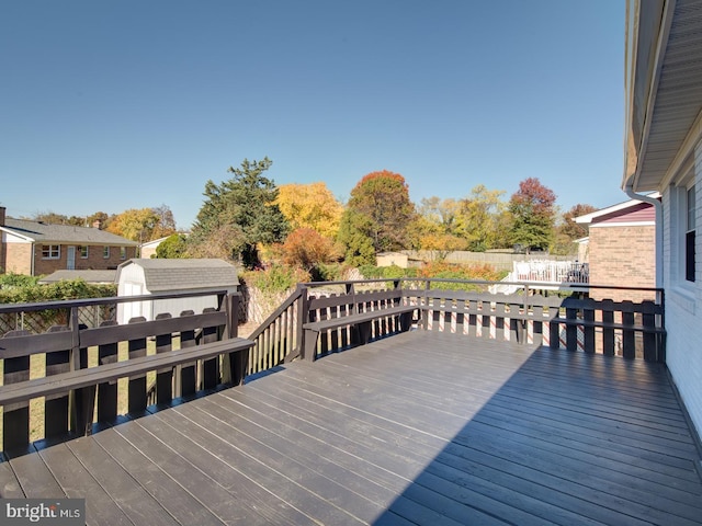 wooden deck featuring a shed