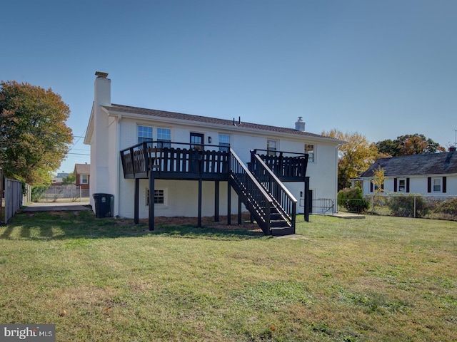 rear view of house featuring a yard and a deck