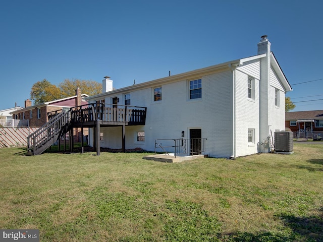 back of property with a lawn, cooling unit, and a wooden deck