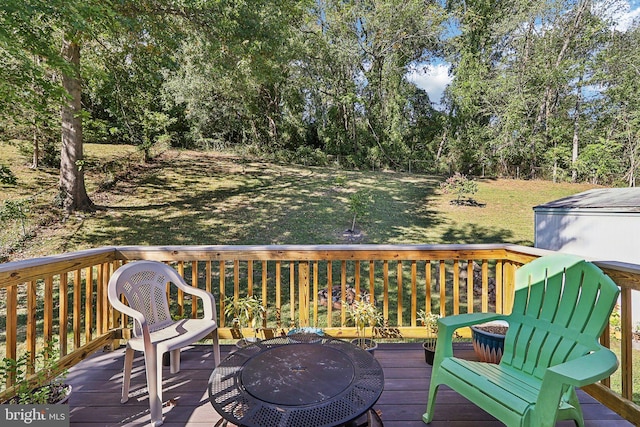 wooden terrace featuring a fire pit and a yard