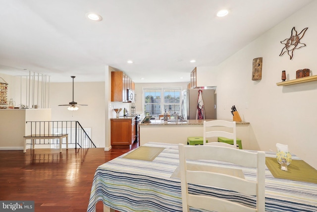 bedroom featuring stainless steel refrigerator and dark hardwood / wood-style floors