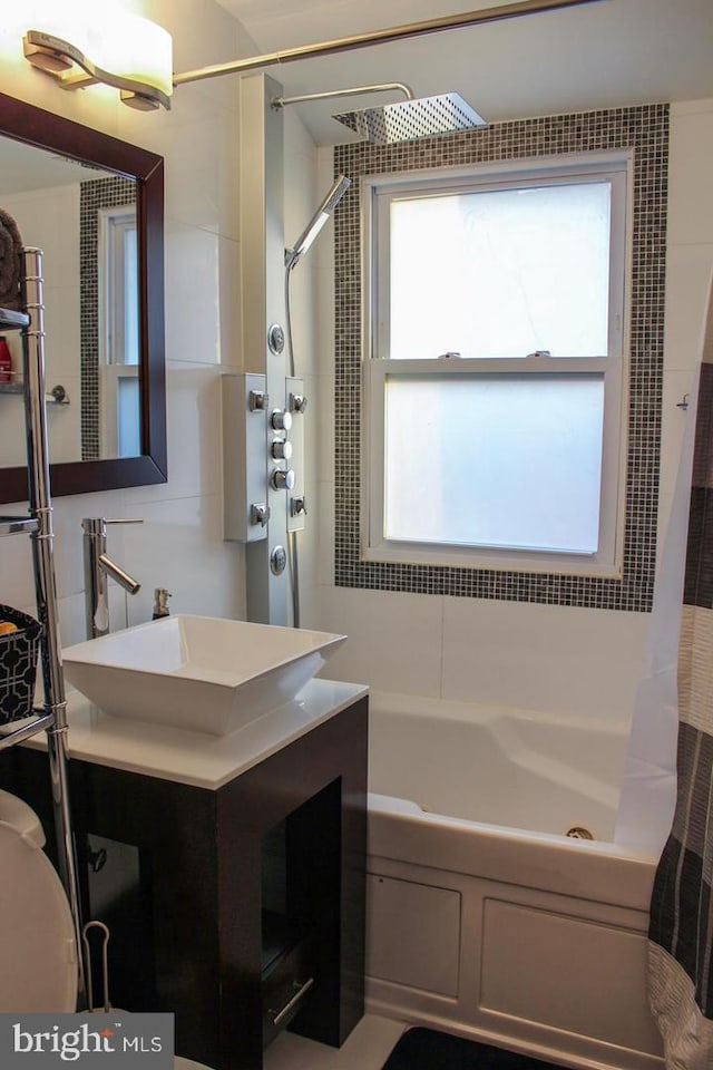 bathroom with vanity and shower / bathtub combination with curtain