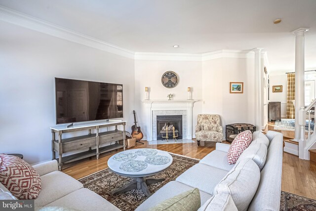 living room with hardwood / wood-style flooring and ornamental molding