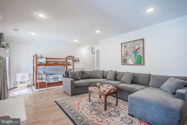 living room featuring light wood-type flooring and crown molding