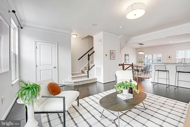 living room featuring dark hardwood / wood-style floors, ornamental molding, and sink