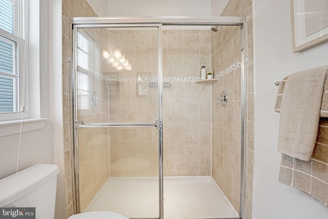 bathroom with toilet and walk in shower